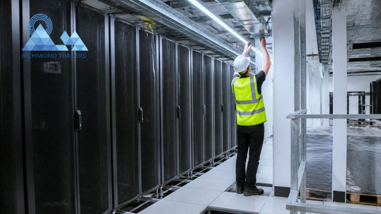 Richmond Traders engineer installing overhead cable tray above server racks during a London data centre fit-out